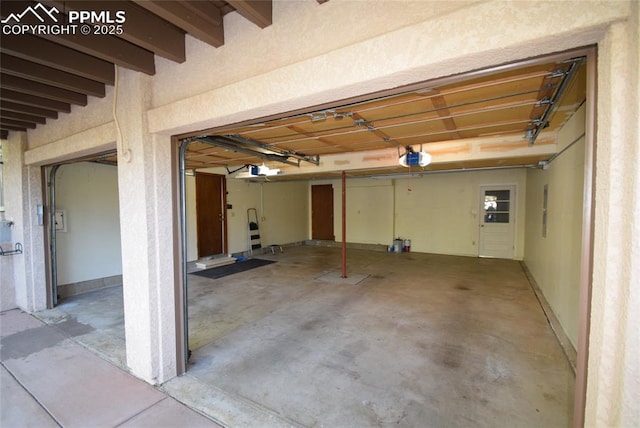 garage featuring a garage door opener and electric panel