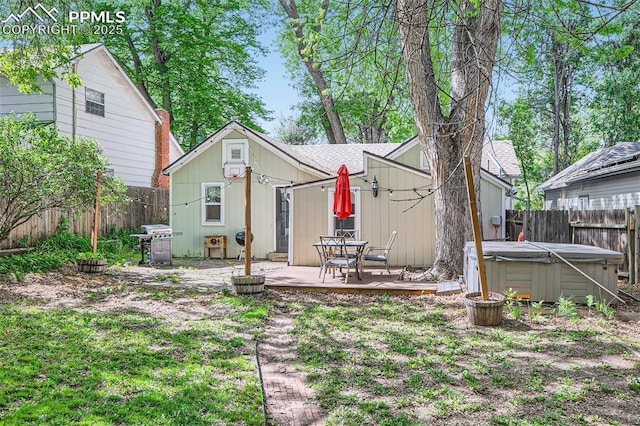 738 E Cache La Poudre St, Colorado Springs, CO 80903 - back of house with a deck, a fenced backyard, a hot tub, and a shingled roof