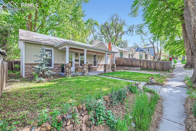 738 E Cache La Poudre St, Colorado Springs, CO 80903 - view of front of home featuring covered porch, stone siding, and board and batten siding