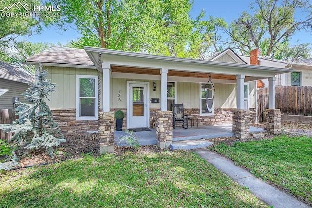 738 E Cache La Poudre St, Colorado Springs, CO 80903 - view of front of property with stone siding, covered porch, and a chimney