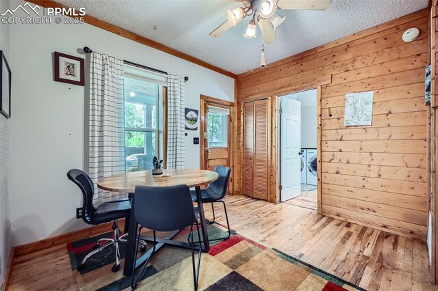 738 E Cache La Poudre St, Colorado Springs, CO 80903 - dining space with light wood-style flooring, ceiling fan, wood walls, a textured ceiling, and baseboards