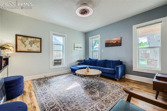 738 E Cache La Poudre St, Colorado Springs, CO 80903 - living area featuring a textured ceiling, wood finished floors, baseboards, and cooling unit