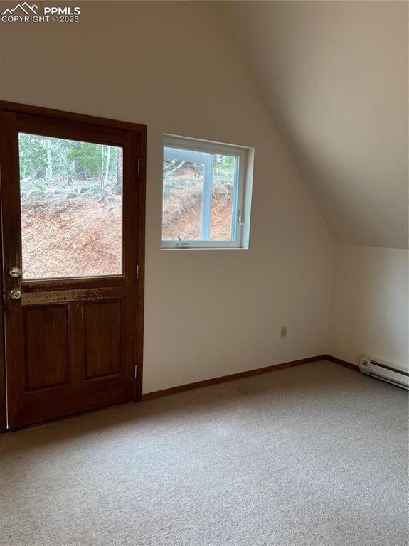 646 Grey Eagle Dr, Cripple Creek, CO 80813 - additional living space with light carpet, vaulted ceiling, baseboards, and a baseboard heating unit