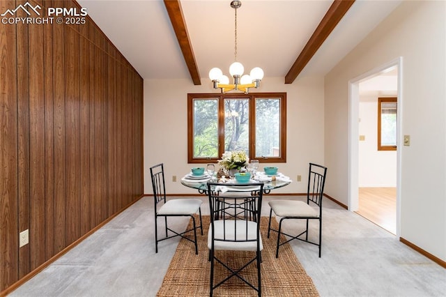 6331 Mesedge Dr, Colorado Springs, CO 80919 - dining room with a chandelier, light carpet, beam ceiling, wooden walls, and baseboards