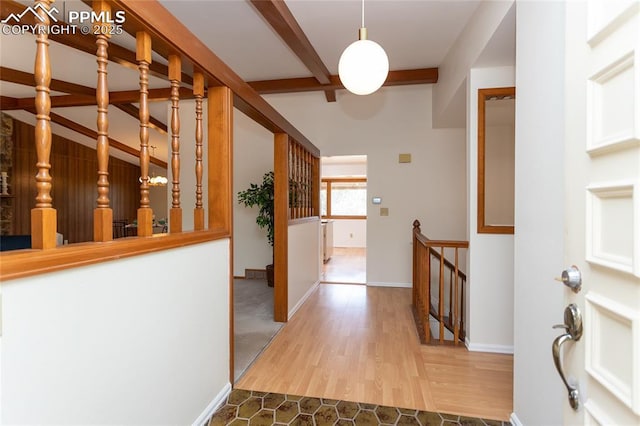 6331 Mesedge Dr, Colorado Springs, CO 80919 - entryway featuring beam ceiling, wood finished floors, and baseboards