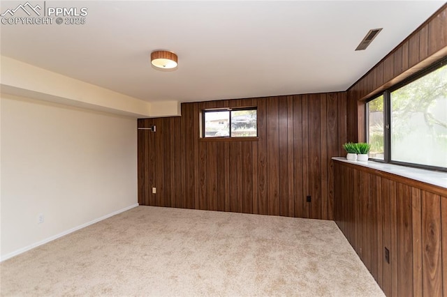 6331 Mesedge Dr, Colorado Springs, CO 80919 - carpeted spare room with healthy amount of natural light, wood walls, and baseboards