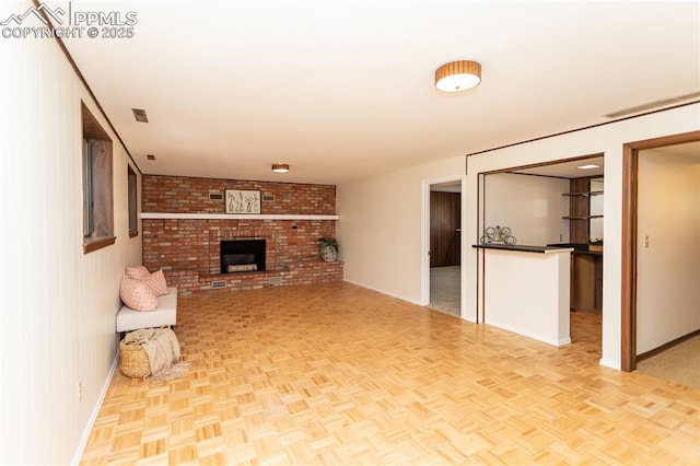 6331 Mesedge Dr, Colorado Springs, CO 80919 - unfurnished living room featuring baseboards and a brick fireplace
