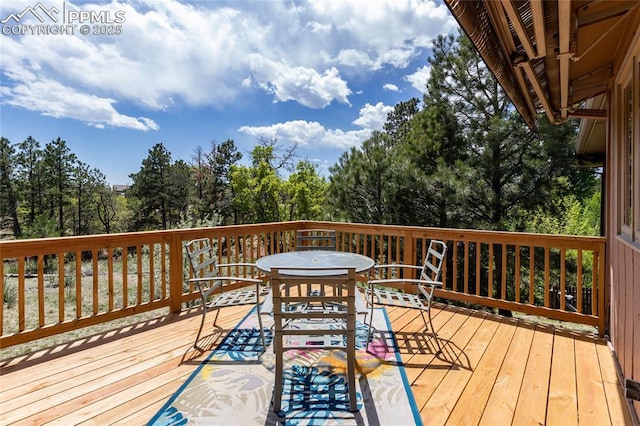 6331 Mesedge Dr, Colorado Springs, CO 80919 - deck featuring outdoor dining area and view of wooded area