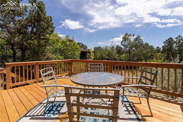 6331 Mesedge Dr, Colorado Springs, CO 80919 - deck with outdoor dining area and view of scattered trees