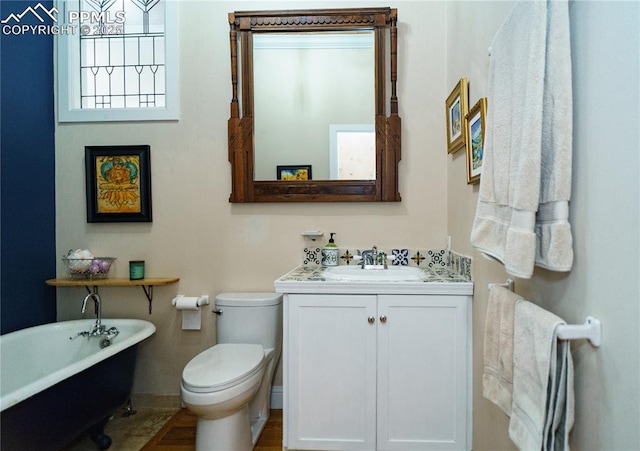 15 Cypress Ln, Colorado Springs, CO 80906 - bathroom with a freestanding tub, vanity, baseboards, and toilet