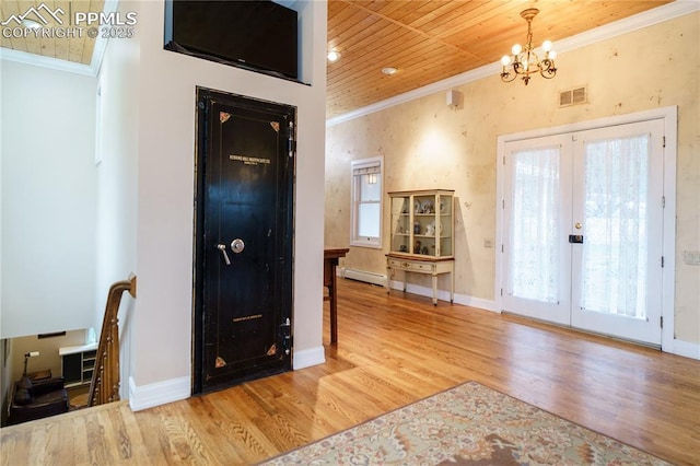 15 Cypress Ln, Colorado Springs, CO 80906 - entrance foyer featuring a baseboard radiator, ornamental molding, french doors, a chandelier, and wood finished floors