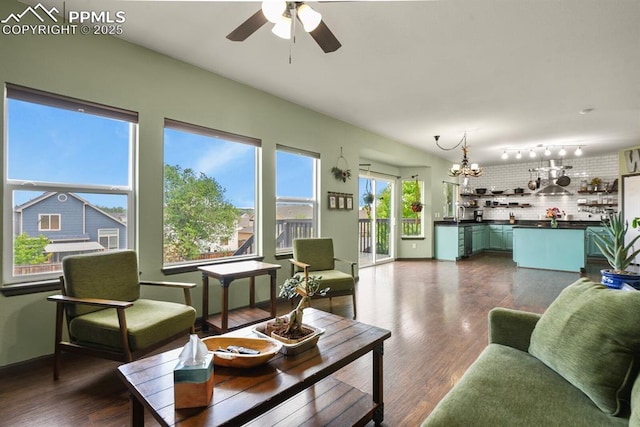 7534 Sistine Ln, Fountain, CO 80817 - living room featuring a ceiling fan, a chandelier, and dark wood-style flooring