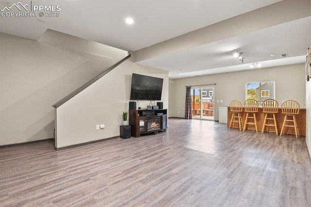 7534 Sistine Ln, Fountain, CO 80817 - living room featuring wood finished floors, stairway, baseboards, and recessed lighting