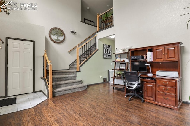 7534 Sistine Ln, Fountain, CO 80817 - home office with wood finished floors, a high ceiling, and baseboards