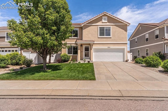 8020 Firecracker Trl, Fountain, CO 80817 - view of front of house featuring stucco siding, an attached garage, driveway, a front yard, and a tiled roof