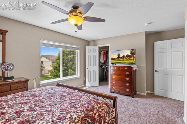 8020 Firecracker Trl, Fountain, CO 80817 - bedroom with carpet floors, a spacious closet, a ceiling fan, and a closet