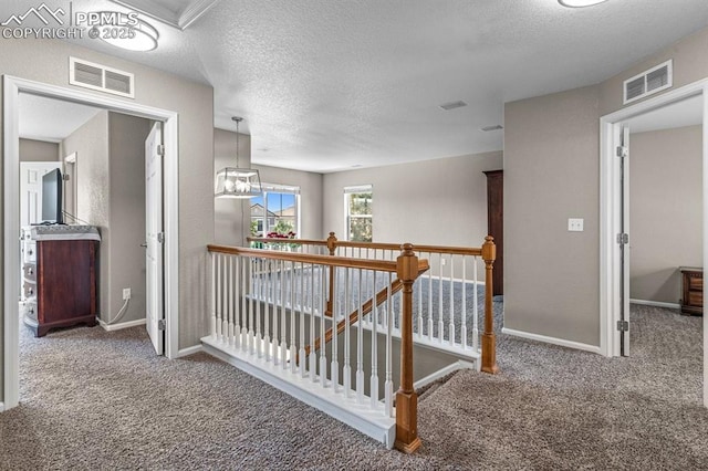 8020 Firecracker Trl, Fountain, CO 80817 - hall with an upstairs landing, carpet flooring, baseboards, and a textured ceiling