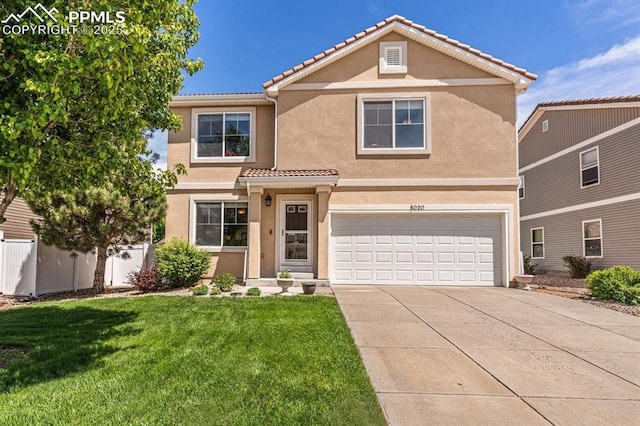 8020 Firecracker Trl, Fountain, CO 80817 - traditional-style house with an attached garage, driveway, stucco siding, and a tiled roof