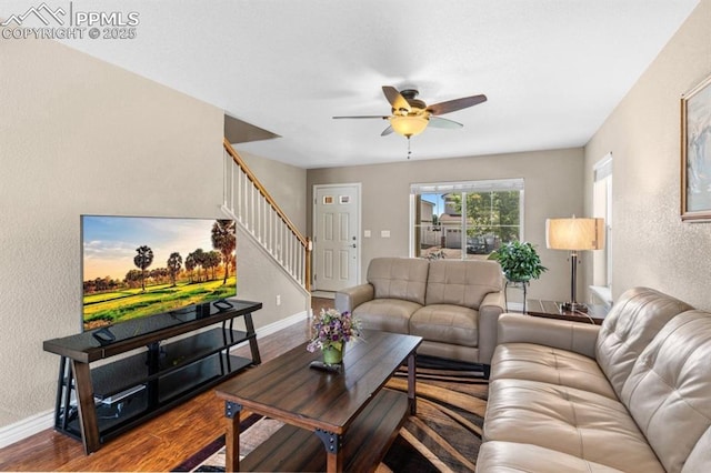 8020 Firecracker Trl, Fountain, CO 80817 - living room with stairs, a textured wall, a ceiling fan, baseboards, and wood finished floors