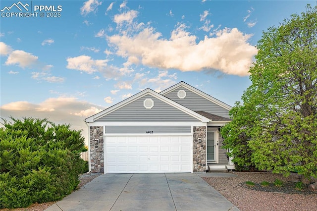 6463 Binder Dr, Colorado Springs, CO 80923 - view of front facade with stone siding, driveway, and a garage
