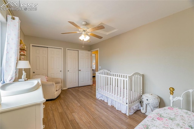 6463 Binder Dr, Colorado Springs, CO 80923 - bedroom featuring two closets, light wood finished floors, and a ceiling fan