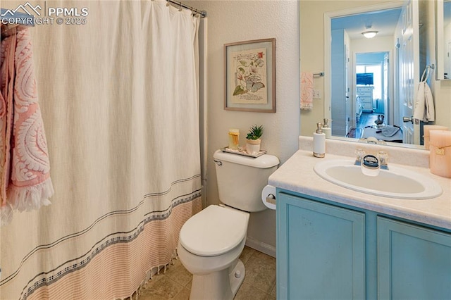 6463 Binder Dr, Colorado Springs, CO 80923 - full bath featuring toilet, vanity, tile patterned flooring, and a shower with shower curtain