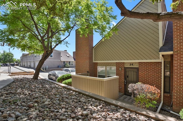 3300 W Florida Ave Unit 26, Denver, CO 80219 - view of side of property featuring a chimney and brick siding