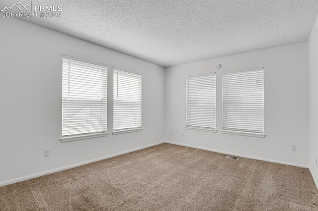3300 W Florida Ave Unit 26, Denver, CO 80219 - carpeted spare room featuring a textured ceiling and baseboards