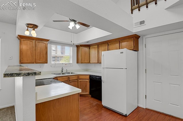 3300 W Florida Ave Unit 26, Denver, CO 80219 - kitchen with freestanding refrigerator, black dishwasher, a sink, ceiling fan, and brown cabinets