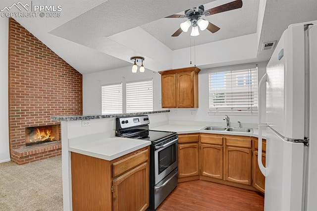 3300 W Florida Ave Unit 26, Denver, CO 80219 - kitchen featuring stainless steel electric range, freestanding refrigerator, a sink, a peninsula, and ceiling fan