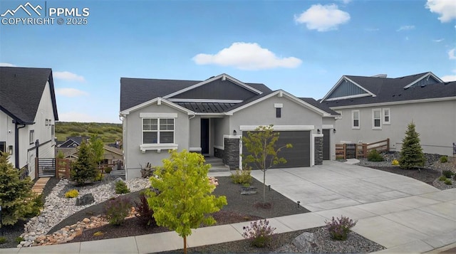 2267 Merlot Dr, Colorado Springs, CO 80921 - craftsman-style home with concrete driveway, stucco siding, a garage, a standing seam roof, and stone siding