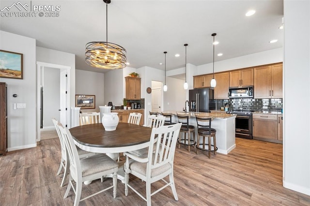 2267 Merlot Dr, Colorado Springs, CO 80921 - dining space featuring light wood-style floors, recessed lighting, a chandelier, and baseboards