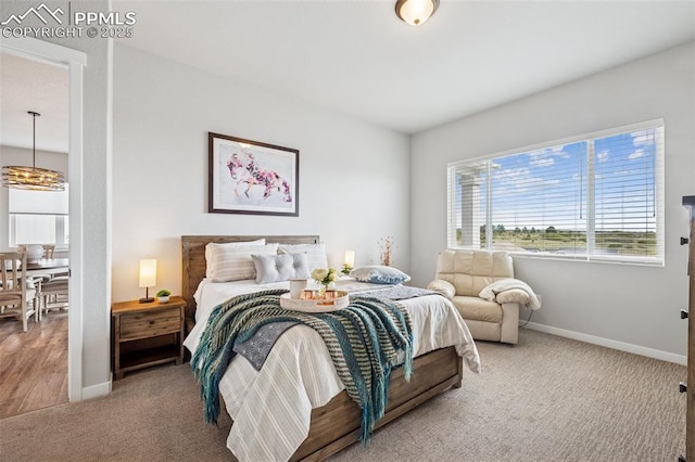 2267 Merlot Dr, Colorado Springs, CO 80921 - bedroom with carpet flooring, baseboards, and a chandelier