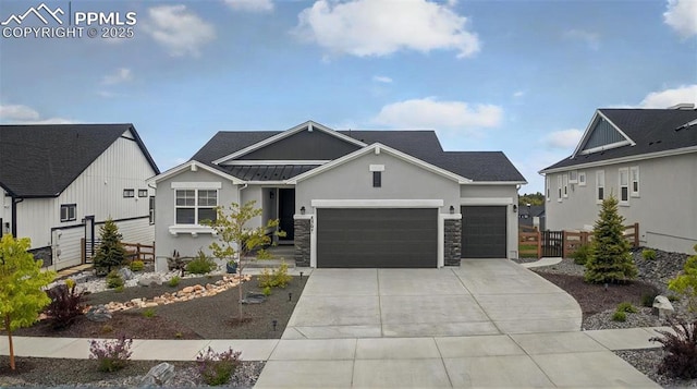 2267 Merlot Dr, Colorado Springs, CO 80921 - view of front facade featuring an attached garage, concrete driveway, a standing seam roof, stone siding, and metal roof