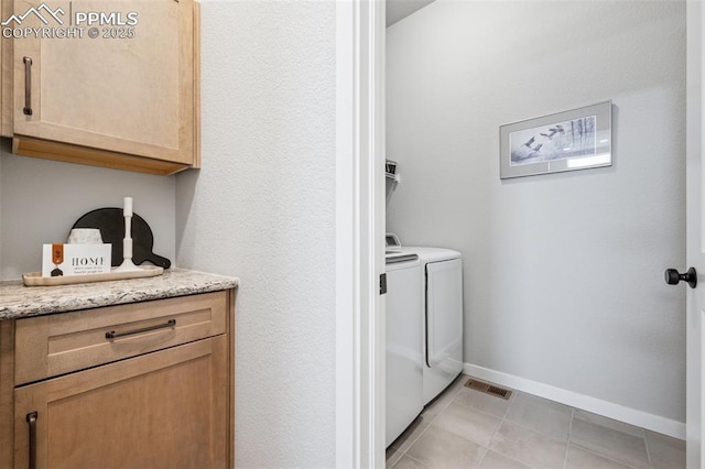 2267 Merlot Dr, Colorado Springs, CO 80921 - laundry area featuring washer and clothes dryer, light tile patterned floors, baseboards, and cabinet space