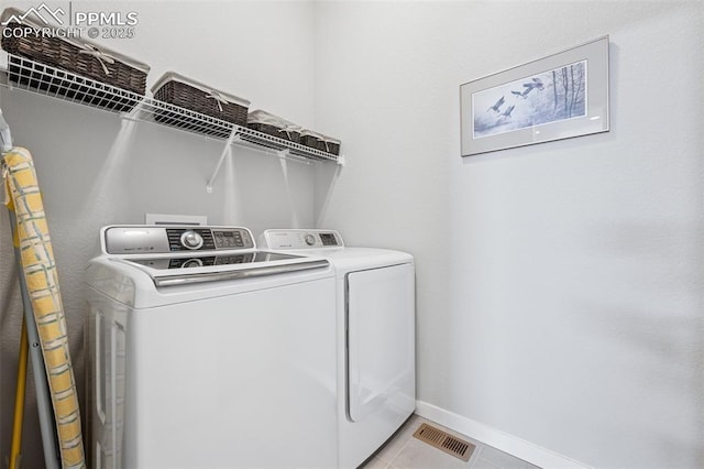 2267 Merlot Dr, Colorado Springs, CO 80921 - washroom featuring independent washer and dryer, baseboards, and light tile patterned floors