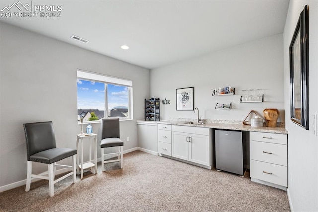 2267 Merlot Dr, Colorado Springs, CO 80921 - indoor wet bar featuring refrigerator, light carpet, baseboards, and recessed lighting