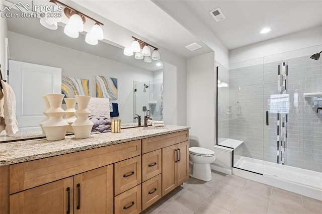 2267 Merlot Dr, Colorado Springs, CO 80921 - bathroom with vanity, a stall shower, toilet, and tile patterned floors
