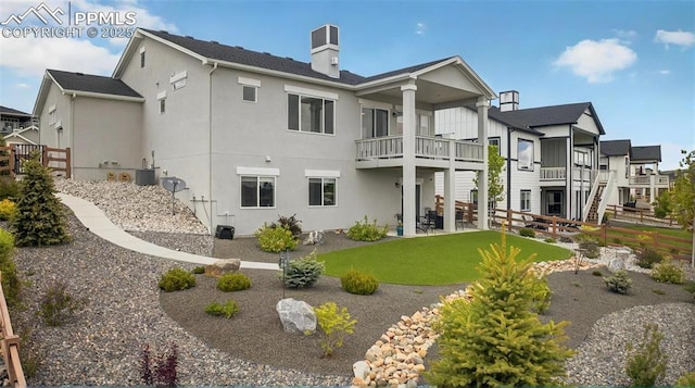 2267 Merlot Dr, Colorado Springs, CO 80921 - back of house featuring a balcony, stucco siding, a chimney, and a patio