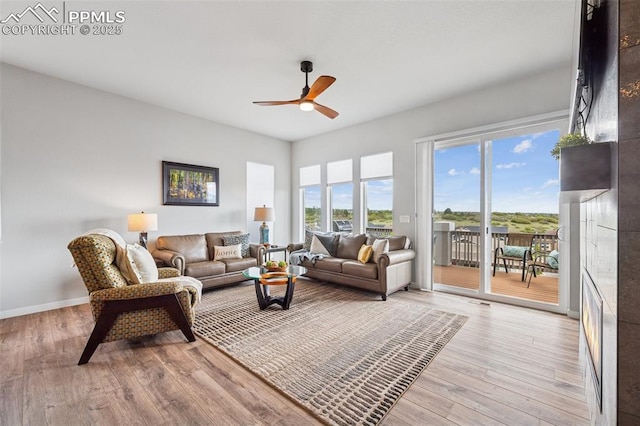 2267 Merlot Dr, Colorado Springs, CO 80921 - living room featuring ceiling fan, light wood-style floors, and baseboards