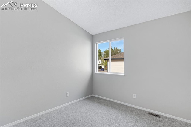 4465 Archwood Dr, Colorado Springs, CO 80920 - carpeted spare room featuring baseboards, vaulted ceiling, and a textured ceiling