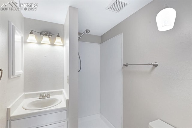 4465 Archwood Dr, Colorado Springs, CO 80920 - bathroom featuring a shower, toilet, and vanity