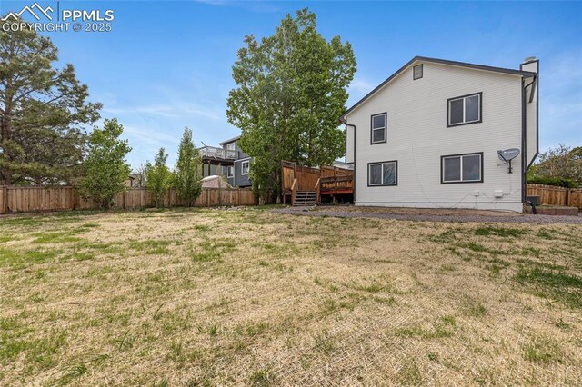 4465 Archwood Dr, Colorado Springs, CO 80920 - rear view of property with a wooden deck and a chimney