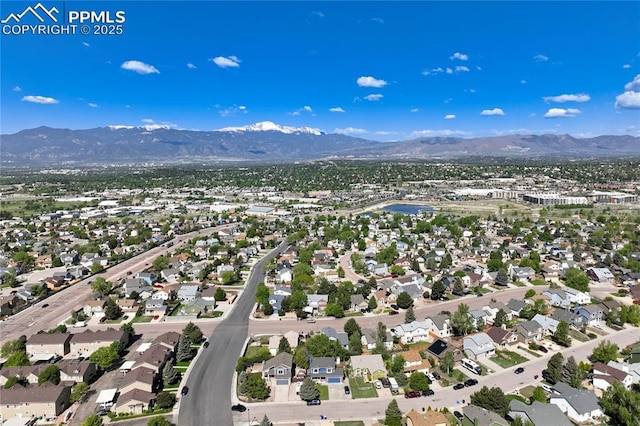2620 Warrenton Way, Colorado Springs, CO 80922 - aerial overview of property's location with mountains and nearby suburban area