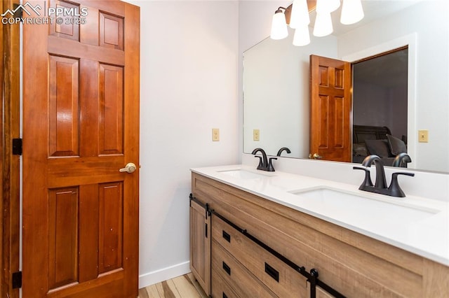 7815 Mallard Dr, Peyton, CO 80831 - full bath with double vanity, wood finished floors, and baseboards