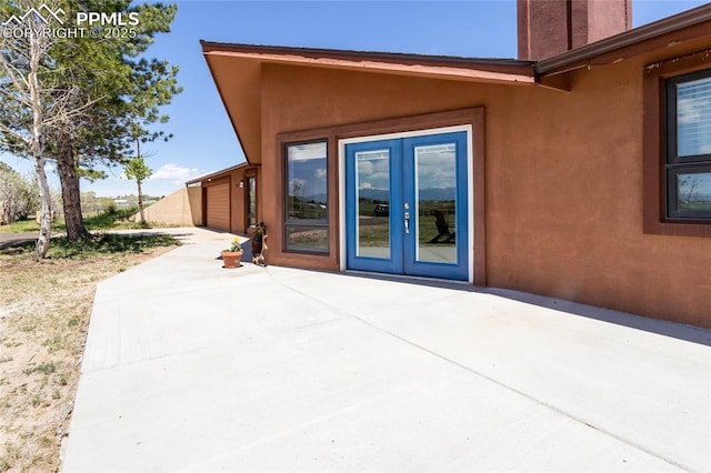 7815 Mallard Dr, Peyton, CO 80831 - view of exterior entry featuring a patio, french doors, and stucco siding