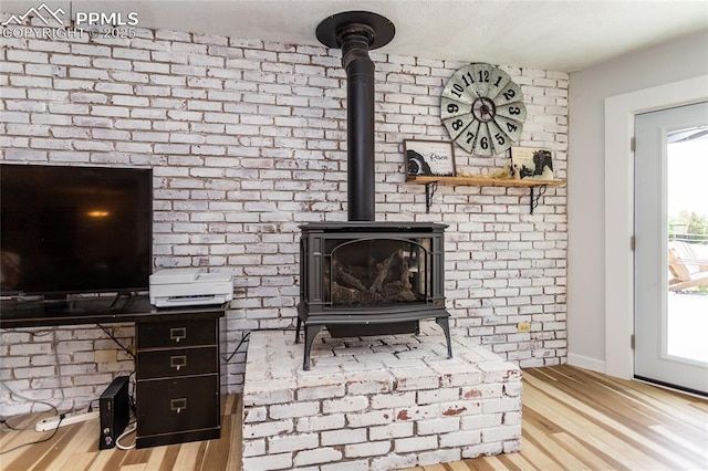 7815 Mallard Dr, Peyton, CO 80831 - detailed view of a wood stove, wood finished floors, and baseboards
