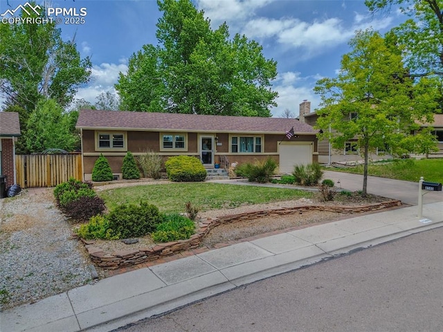 4580 N Sleepy Hollow Cir, Colorado Springs, CO 80917 - single story home with a garage, concrete driveway, stucco siding, and a chimney