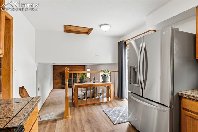 7350 Devinney Ct, Arvada, CO 80005 - kitchen with stainless steel refrigerator with ice dispenser, light wood-type flooring, and tile counters