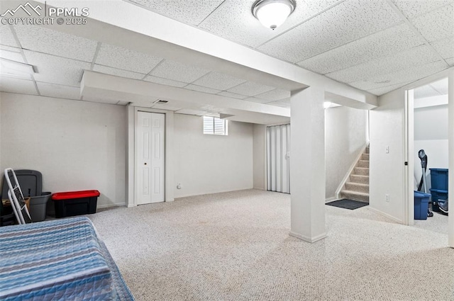7350 Devinney Ct, Arvada, CO 80005 - basement with a drop ceiling, carpet flooring, stairway, and baseboards